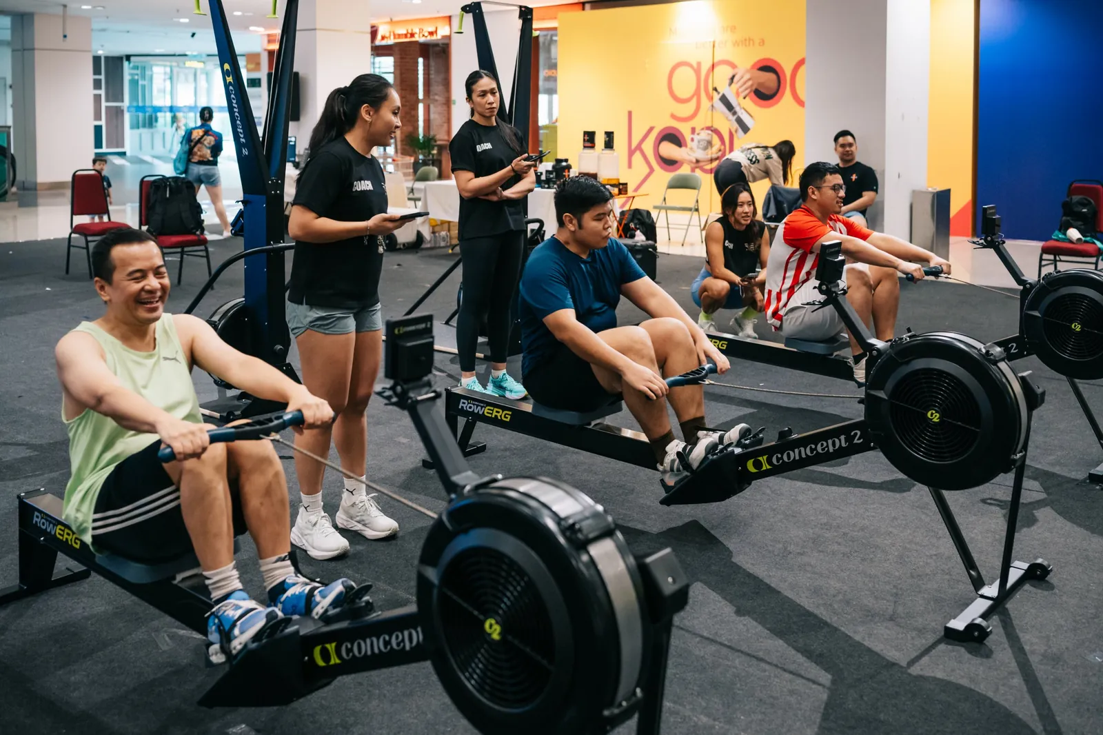 A row of rowers going at once, coaches timing them