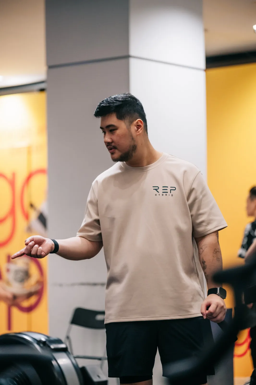 A coach in the REP tee calling the next athlete