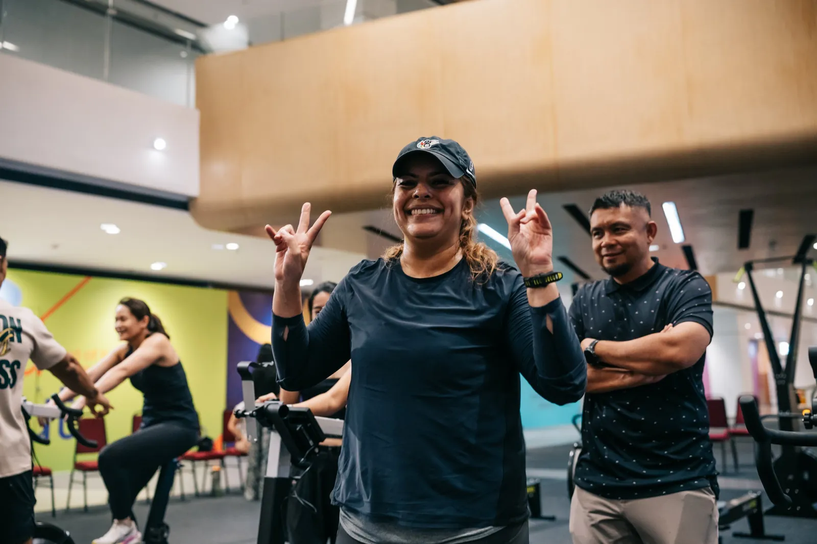An athlete throwing peace signs after her piece