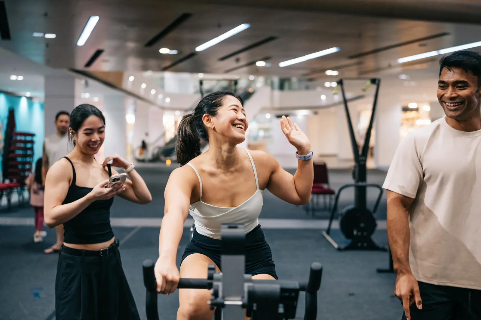 An athlete laughing on the bike while friends film