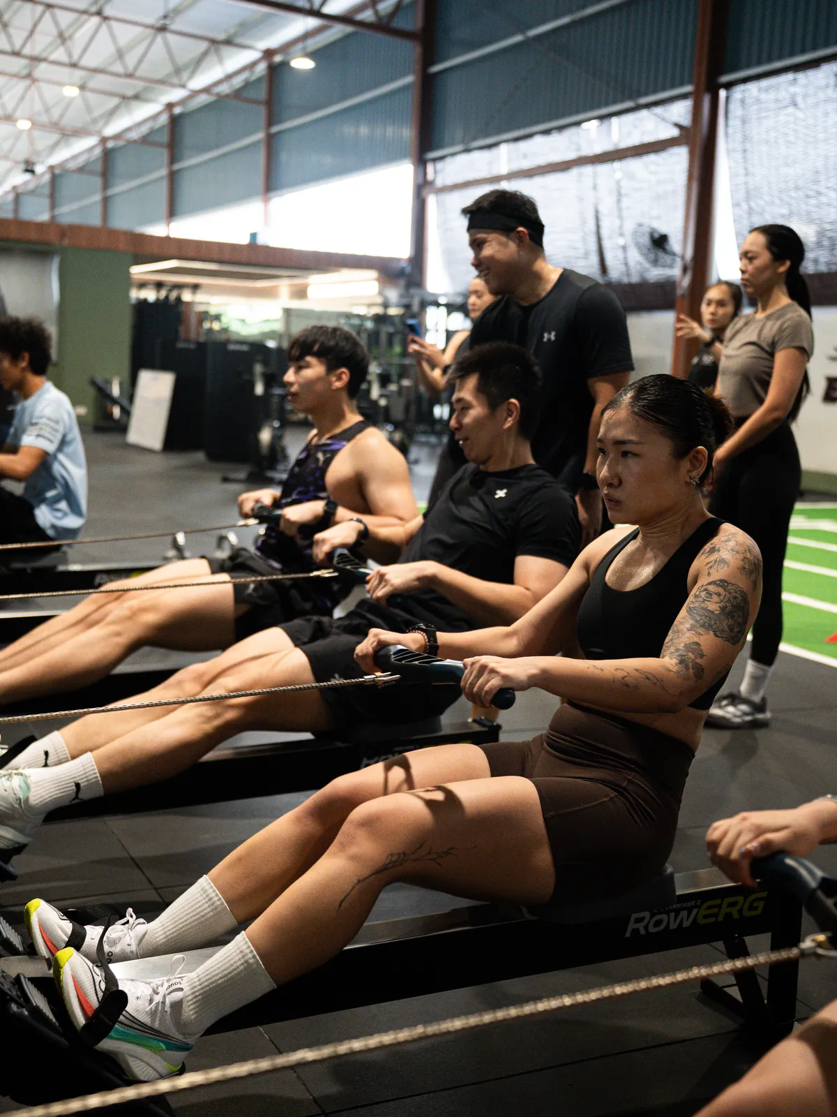 A line of rowers pulling together on the RowErgs